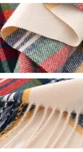Macro view of soft faux cashmere plaid scarf showing woven texture and delicate tassels