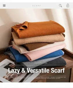 Close-up of stacked solid color wool-like scarves with tassel details in various earthy tones.