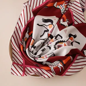 Detailed close-up of 16mm twill mulberry silk scarf with elegant horse print.