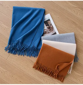 Detailed layout of soft winter fringed scarves in blue, gray, cream and orange