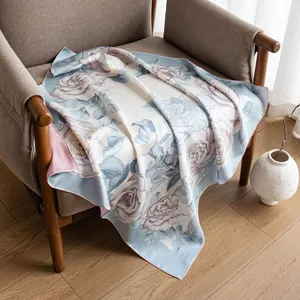 Luxury 16mm twill mulberry silk scarf with elegant blue rose floral print on chair