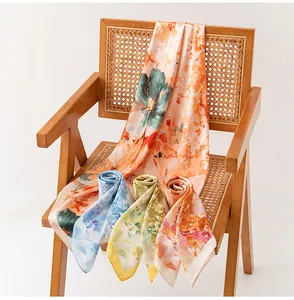 Detailed view of lightweight floral silk scarves draped on a rattan chair