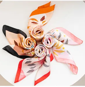 Detailed view of five elegant floral printed silk scarves arranged in a circular flower pattern.