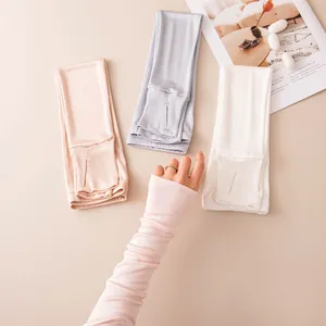 Macro detail of breathable silk sunscreen sleeve with thumb hole worn on female arm