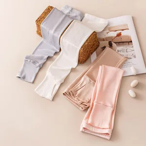 Detail showing four pastel colors of silk sun protection arm sleeves for women