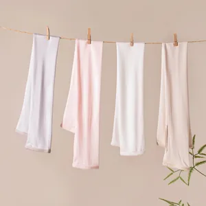 Pastel colored mulberry silk long sun protection arm sleeves hanging on a clothesline