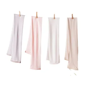 Premium mulberry silk sun protection arm sleeves in four soft colors hanging on a line