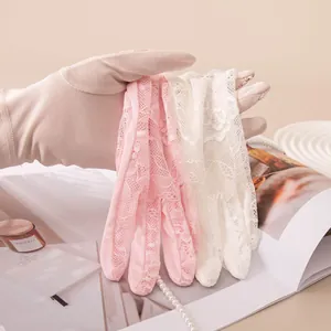 Detailaufnahme der Seiden-Sonnenschutzhandschuhe mit feinem floralem Spitzenmuster
