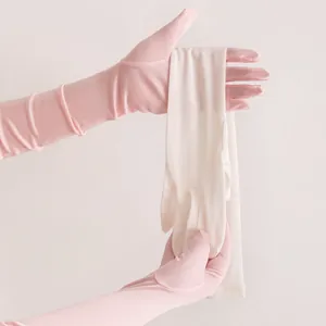 Detailed view showing the texture of pink and white long silk sun protection gloves
