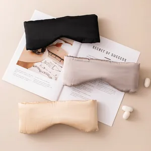 Pure mulberry silk sleep masks in black, taupe, and gold on a magazine background