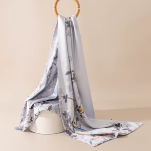 Close-up of elegant New Chinese style silk shawl with bird and flower prints.