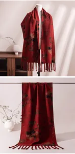 Detailed display of red Chinese style silk scarf featuring elegant floral patterns and tassels