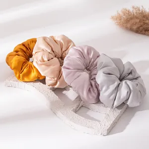 Assorted silk satin scrunchies in elegant solid colors for ponytail hair styling