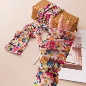 Close-up of floral print mesh sun protection arm sleeves with fingerless design