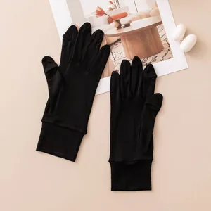 Close-up shot of black mulberry silk sun protection touchscreen gloves with cocoons