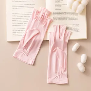 Detalle de guantes sin dedos de seda rosa transpirable para el sol de verano