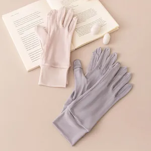 Detailed view of thin mulberry silk sun protection gloves in pink and grey colors