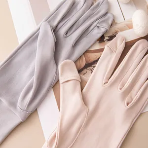 Macro view of lightweight mulberry silk sun protection gloves with touchscreen fingertips.