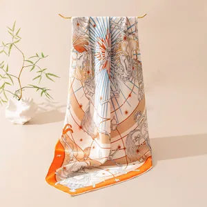 Detailed view of luxury mulberry silk square scarf featuring intricate orange celestial print