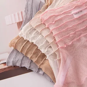 Close-up of ruffled silk mesh neck covers in various pastel colors for sun protection.