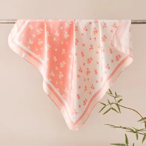 Elegant peach floral print silk square scarf draped to show pattern and texture