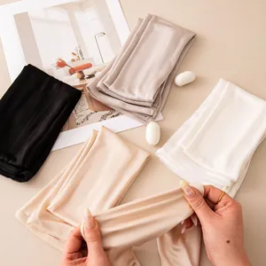 Detail of breathable silk sun protection arm sleeves showing elastic material texture.