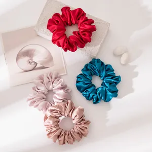Detail view of large satin mulberry silk scrunchies in various elegant and vibrant colors