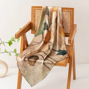 Detail view showing the soft texture and elegant floral print of this mulberry silk square scarf