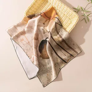 Detail of elegant mulberry silk square scarf with floral print draped over a basket