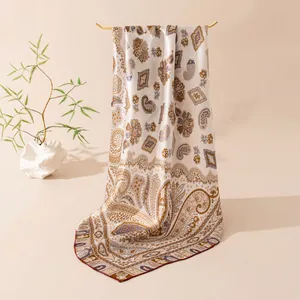 Detail of mulberry silk scarf with classic paisley pattern and handmade rolled edges