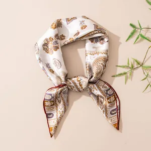 Detailed view of mulberry silk square scarf with vintage paisley print and hand-rolled edge