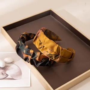 Detail view of handmade silk jacquard headbands featuring vintage floral patterns