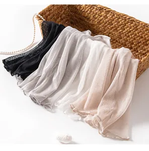 Detailed view of lightweight mulberry silk mesh knitted scarves in black white grey and beige