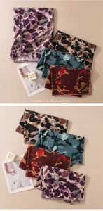 Detailed view of various vintage abstract print pashminas in multiple color combinations