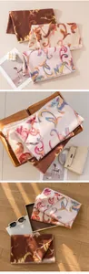 Detail views of elegant floral printed scarves in soft pink and brown earthy tones