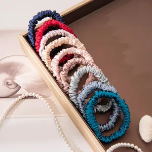 Premium set of colorful 100% mulberry silk scrunchies displayed in an elegant tray