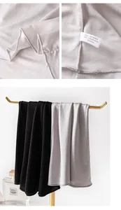 Detail view of 100% mulberry silk neck gaiter fabric and care label information