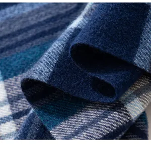 Close-up macro shot of soft blue plaid scarf fabric showing thick warm winter texture