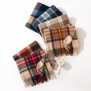 Group of soft cashmere-like plaid scarves with tassels in festive colors for winter