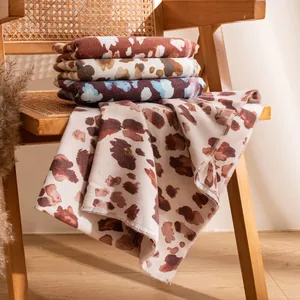 Elegant leopard print autumn winter pashmina scarf displayed on vintage wooden chair
