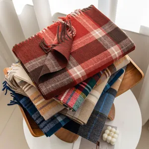 Stack of assorted plaid scarves in red, blue, and yellow cashmere-like fabric