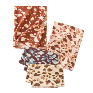 Assorted autumn winter scarves with stylish leopard prints in coffee and beige tones.