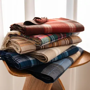 Close-up view of stacked classic plaid scarves with soft imitation cashmere texture.