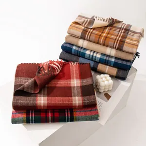 Detailed view of folded plaid faux cashmere scarves in various classic colors for winter