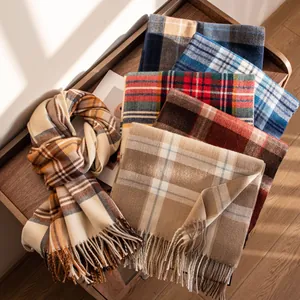 Detailed macro view of assorted plaid cashmere-feel scarves with fringes on a wooden bench