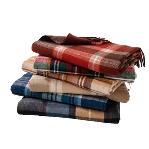 Stack of five classic plaid winter scarves in assorted colors with soft fringe detail