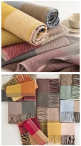 Collection of various colored plaid imitation cashmere scarves with elegant tassels detail