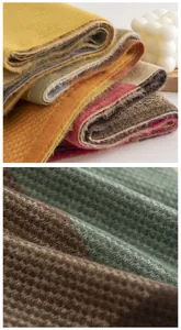 Close-up view showing the soft texture and weave of the multi-colored plaid scarf