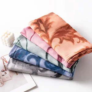 Detailed view of lightweight artistic scarves stacked in several various elegant colors.