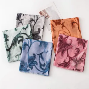 Macro view showing a variety of colorful floral print scarves in multiple shades